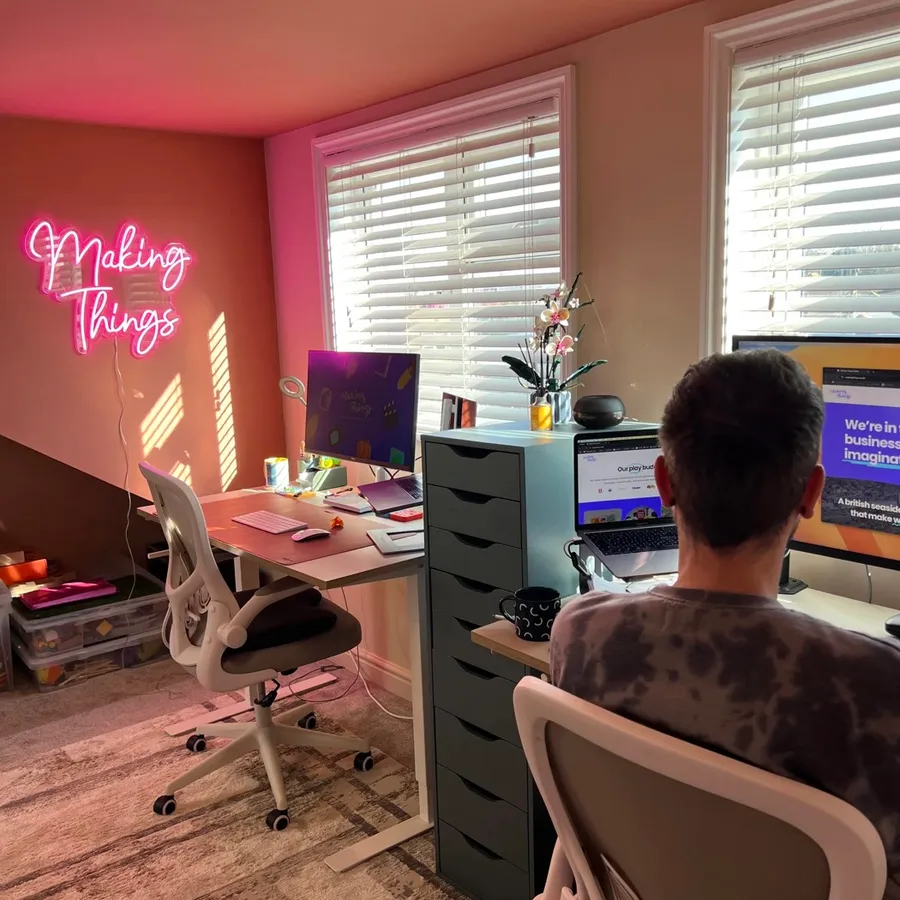 The studio desk under the neon sign