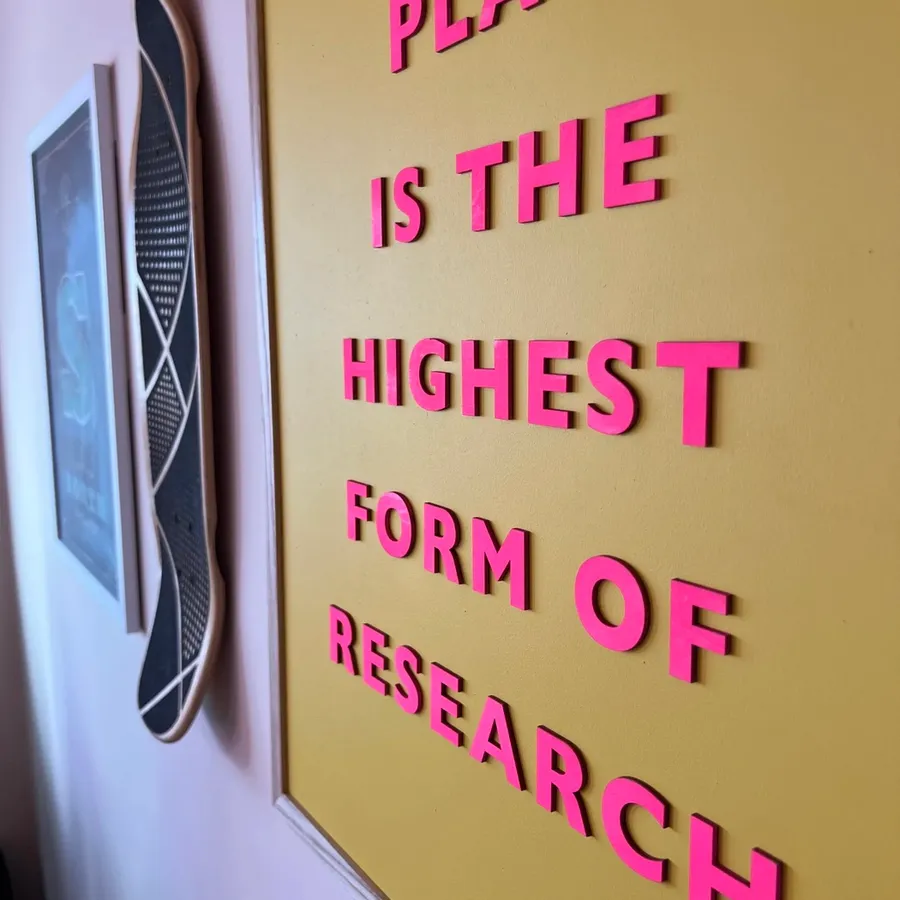 The sign on the studio wall: Play is the highest form of research